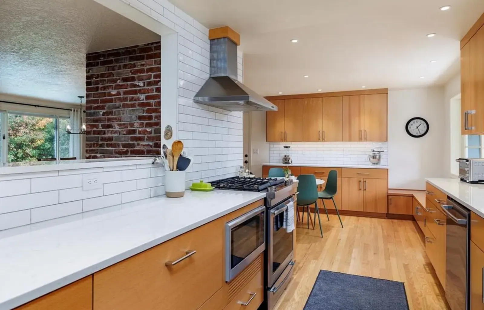 Kitchen with wood cabinets, white counters and a range hood